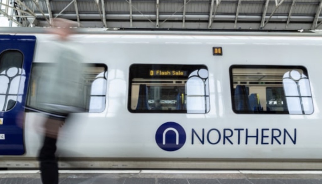 A white northern train at a platform